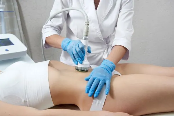 Lost the Weight but Not the Loose Skin? 2 woman having HIFU treatment on her stomach to combat loose skin Nazeing following weight loss